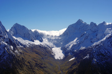 Snow peaks and fresh snow in the mountains in autumn