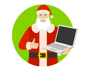 Santa Claus holding laptop computer and showing thumb up