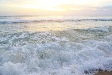 Naklejka na ściany i meble Shiny tropic sea wave on golden beach sand in sunset light.