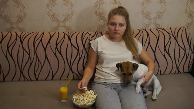 Woman with dog watching tv