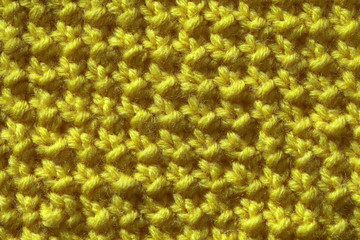 The texture of the knitted fabric is yellow. Fashionable palette Golden Lime of this year.