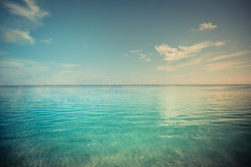 Fototapeta na wymiar Beautiful blue sea and sky with long horizon. Tranquil nature landscape banner