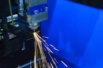 The fiber laser cutting machine cutting the steel pipe with the sparking light.The fire flame from the fiber laser cutting machine.
