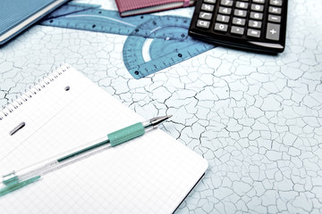 A notebook and pen on wood background