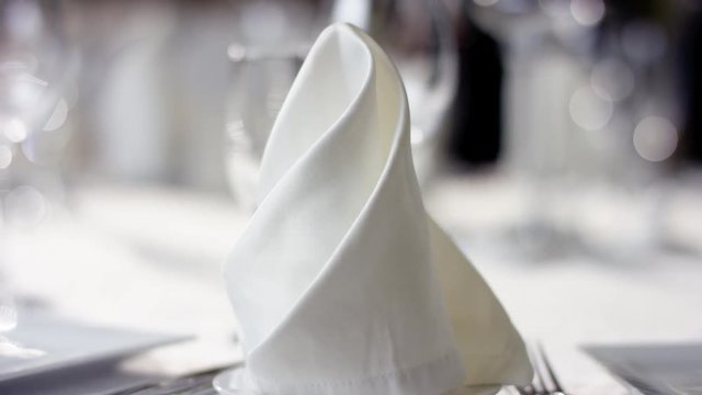 Shot of napkins and wine glasses on banquet table at restaurant