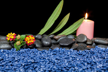 Obraz na płótnie Canvas Spa decoration with stones and candles on a black background