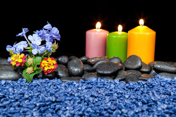 Spa decoration with stones and candles  on a black background