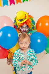 Obraz na płótnie Canvas a terrible clown and a child. Halloween. The crazy clown. Childish fear