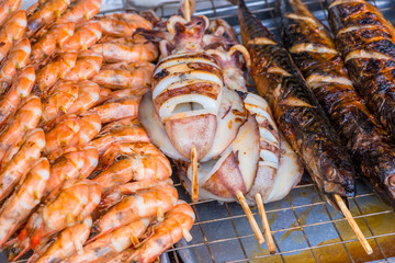 marine life cooked on the grill, close-up photo - Asian food on the street