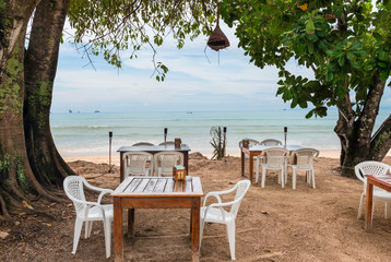 empty tables in a restaurant on the shores of the Andaman Sea, Thailand
