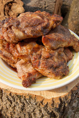 Juicy pork steaks cooked on an open flame grill on big white plate..