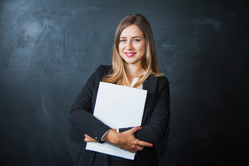 Beautiful businesswoman with blank white sheets on paper, bunch of paper, pad of documents with copy space.