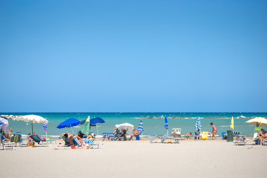 Fototapeta white beaches italy. sea sky people umbrellas sun beds.