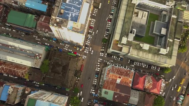 4K Aerial, the camera rises above road junction,streets at China Town and city of Yangon