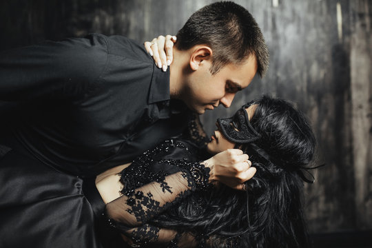 woman  with  theatrical mask and handsome man