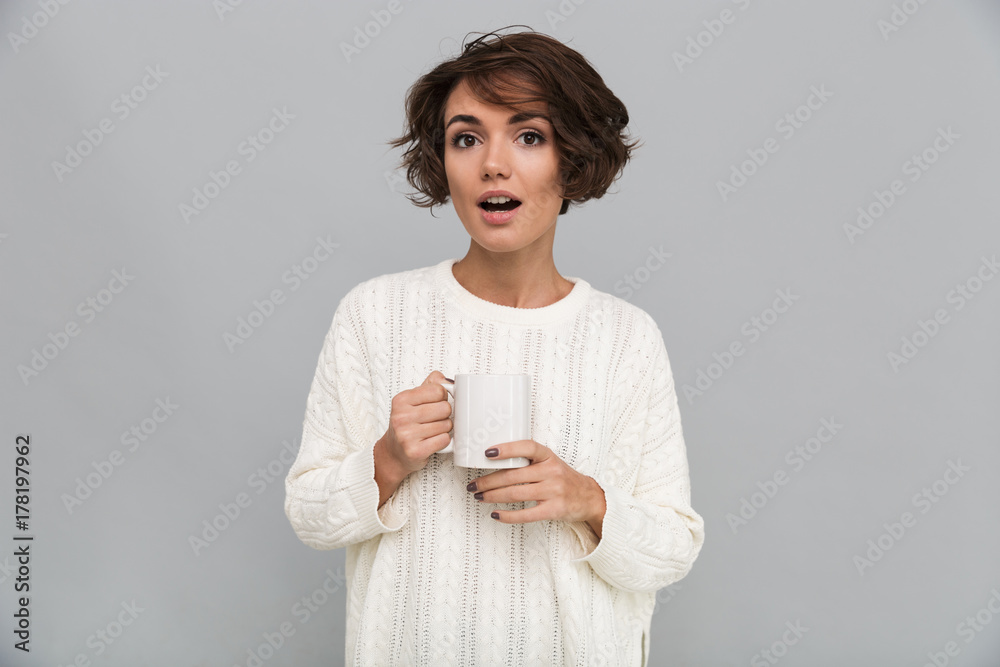 Wall mural Shocked young lady drinking tea.