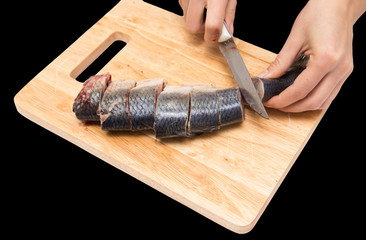 preparation of herring on a board on a black background