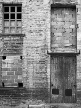 abandoned industrial warehouse building with bricked up windows and locked door in halifax yorkshire