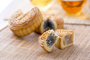 Closeup of moon cake and tea - Chinese mid-autumn festival food on table. 
