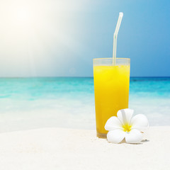 Cocktails in glass on white sandy beach
