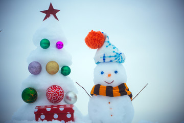 Snowman with smiley face in hat and scarf