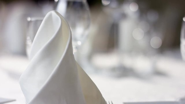 Shot of wine glasses and napkins on banquet table at luxury restaurant Meliot