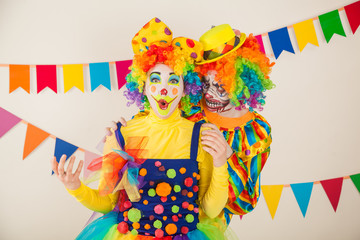 a terrible clown and a good clown. Halloween. The crazy clown and clowness.