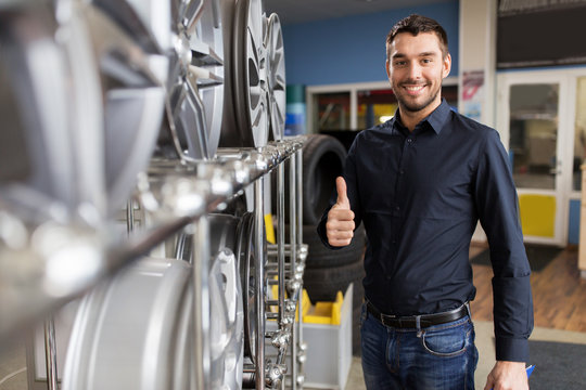 male customer choosing wheel rims at car service