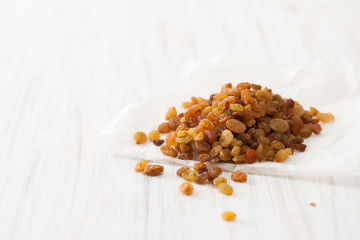 Raisins (dried grapes) on a white table