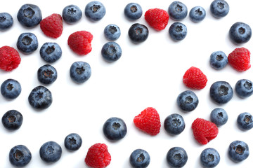 mix of blueberries, raspberries isolated on white background. top view with copy space