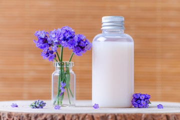 natural cosmetic bottle with fresh lavender flowers