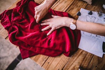 Close-up of female fashion designer working with textiles