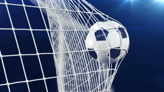 Soccer Ball flying in Goal Net in Slow Motion. Black Background and Flares. Sport Concept. Beautiful Football 3d animation of the Goal Moment. 4k Ultra HD 3840x2160.