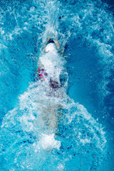 woman swimming with swimming hat in swimming pool