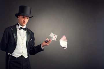 magician holding playing cards