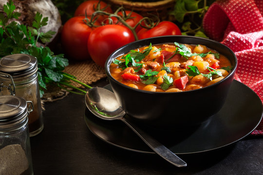 White bean soup with potatoes, tomatoes, paprika, and bacon