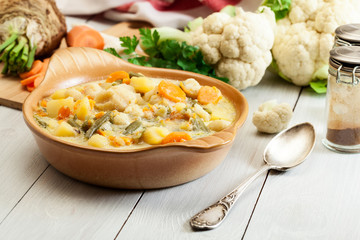 Vegetable soup with ingredients carrot, cauliflower, potato and