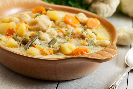 Vegetable soup with ingredients carrot, cauliflower, potato and