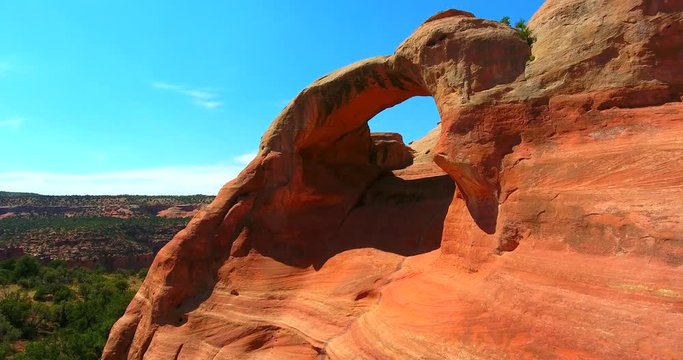 Red Sandstone Arch Against Blue Sky In Desert Landscape - Moving Aerial Shot - Rattlesnake Arches In Colorado, USA