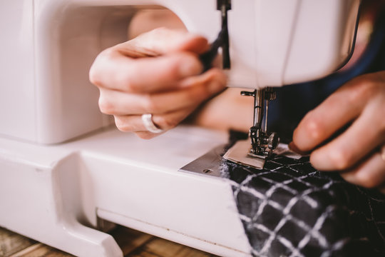 Close-up of woman sewing with sewing machine