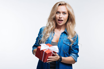 Beautiful fair-haired woman posing with a gift box