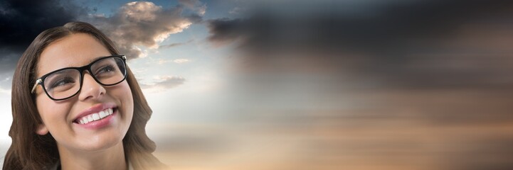 Woman looking up with cloudy background