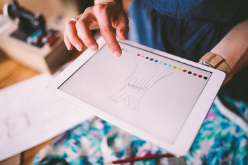 Fashion designer drawing template on digital device