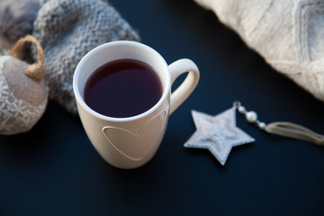 hot tea in white cup and Christmas decorations - cozy winter day