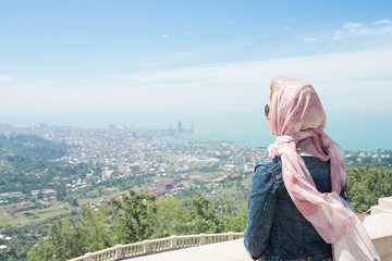 Woman enjoying beautiful view on Batumi and sea from Sameba Church. Batumi, Georgia.