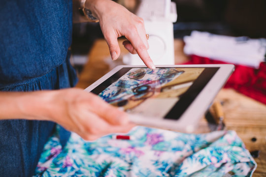 Woman taking photo with digital tablet