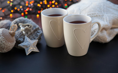 hot tea in white cup and Christmas decorations - cozy winter day