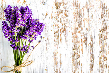Lavender bouquet on white wooden background, top view