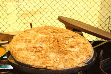 A big roti in a big plate