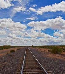 Fototapeta premium Straight tracks to horizon, cloudy skies